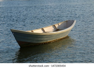 A Boat Tranquilly Rests In The Kennebunk River In Downtown Kennebunkport