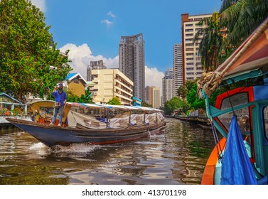 Boat transporting passengers and tourist down Chao Praya river , Bangkok , Thailand 