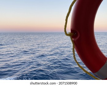 Boat trip on a boat, a lifebuoy on the background of the blue sea, the view from the ship. Concept of summer vacation at sea, sea cruise.