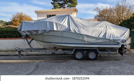 Boat Under Tarpaulin Tarp On Car Trailer