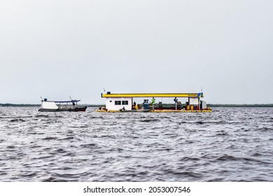 A boat waiting to fill the fuel at Floating Petrol Station Ipiranga, on the Rio Negro river, Amazon, Brazil