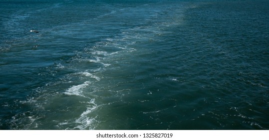 Boat Wake Behind Boat On The Ocean On A Sunny Day In Mediterranean.