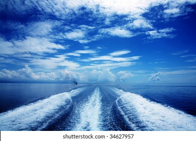 Boat wake in the sea, on a brilliant sunny day.