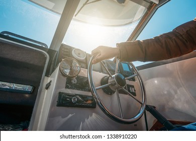 Boat Or Yacht Captain Hand On Boat Steering Wheel And Sea Navigation System, Close Up