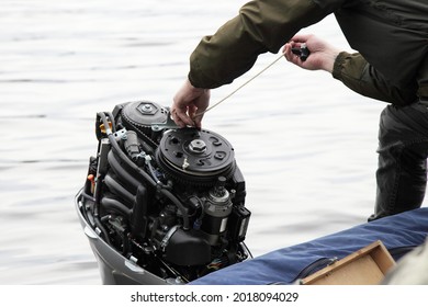 Boater hand start an outboard boat motor without the hood cap on the transom of the boat, emergency engine start with rope when broken starter or battery