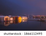 Boathouses reflected on Kootenay Lake on a calm winter