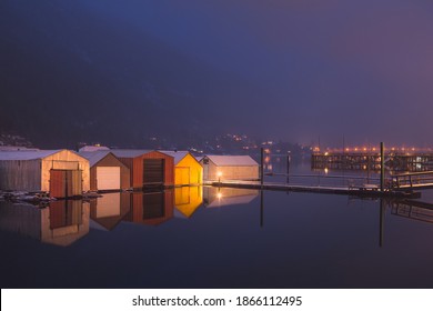 Boathouses reflected on Kootenay Lake on a calm winter's evening in Nelson, B.C., Canada. - Powered by Shutterstock