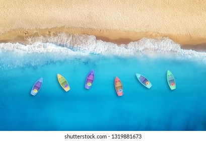 Boats from air. Aerial view on sea in Turkey. Summer seascape with clear water and sandy beach in sunny day. Top view of boats from drone. Summer seascape from air. Travel - image