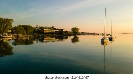 Boats anchored in still water at sunrise near Traverse City Michigan - Shutterstock ID 2164611467