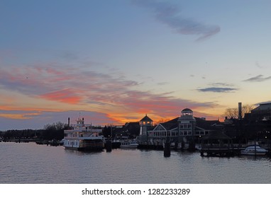 Boats, City Skyline And Waterfront Of Alexandria, Virginia Viewed From The Water At Sunset