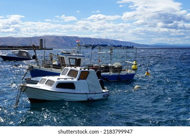 Boats And A Fishing Boat Anchored In The Harbor On The Wavy Rough Sea