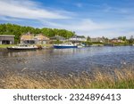 Boats and houses at the shore of Zuidlaardermeer lake in Groningen, Netherlands