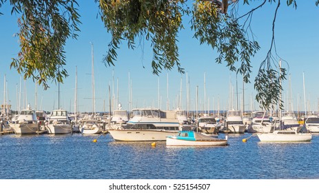 Boats lined up at their moorings in the Swan River in Perth, Western Australia. - Shutterstock ID 525154507