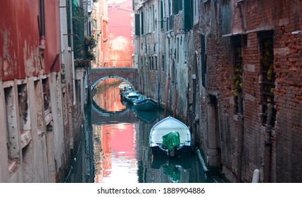 the boats moored on the narrow canals in Venice - Shutterstock ID 1889904886
