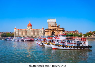 Boats at Mumbai harbor and Gateway of India, an arch monument in Mumbai city, Maharashtra state of India