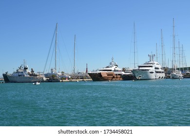 Boats in an ocean harbour on a sunny day with a clear blue sky. 