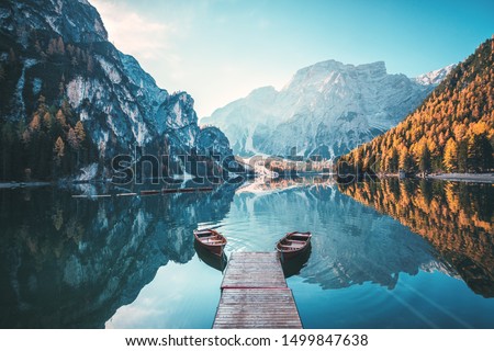 Boats on the Braies Lake ( Pragser Wildsee ) in Dolomites mountains, Sudtirol, Italy