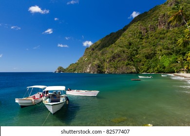 Boats on the clear waters of a beach in Soufriere in St Lucia
