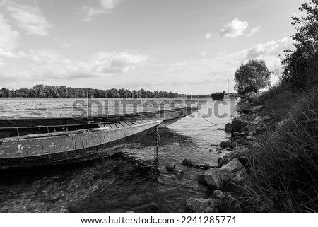 Boats on the Loire river. Gennes-Val-de-Loire, Loira, Loire, Maine-et-Loire. France. Black and white.