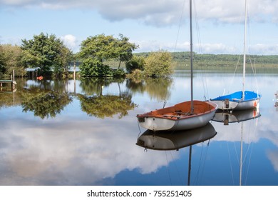 Boats On A Silent Lake With Reflection In Water