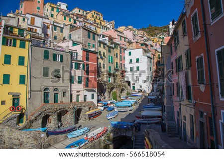 Boats parked in the streets of the old village of Riomaggiore with its colorful houses in the Cinque Terre in Liguria.