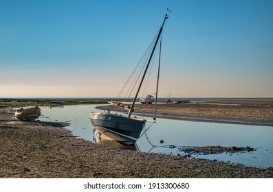 Boats at rest on the beach at Newport in Pembrokeshire in evening light