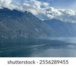 Boats sailing on the mountain lake Garda in the Italian Alps near Pregasina, Riva del Garda, Trentino - Alto Adige, Italy, October 2023