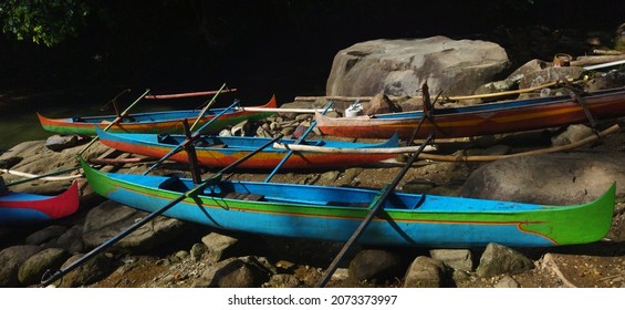Boats Of Seasonal Sailors On A Rocky Beach With A Variety Of Hues That Are Only Seen During The Deepwater Squid Harvest Season Between October And December. Indonesia. Maluku. Ambon. Asia..