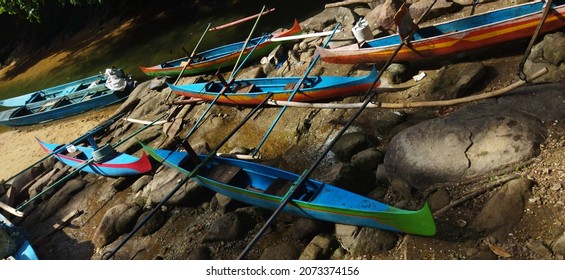 Boats Of Seasonal Sailors On A Rocky Beach With A Variety Of Hues That Are Only Seen During The Deepwater Squid Harvest Season Between October And December. Indonesia. Maluku. Ambon. Asia..
