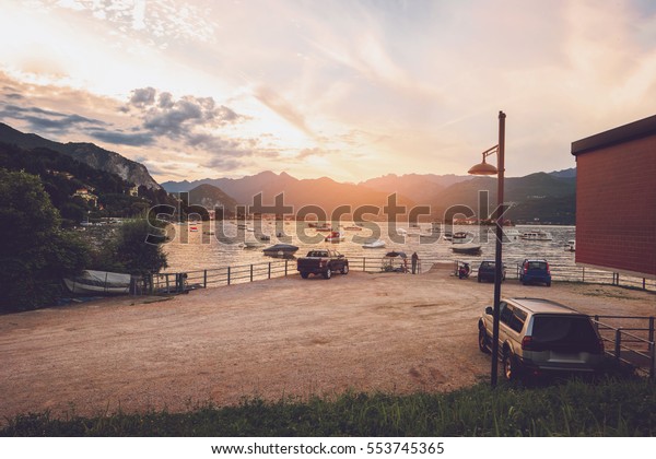 Boats, water and mountains. Landscape at\
sunset. Admire beauty and find\
inspiration.