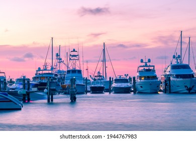 Boats And Yachts Parked In A Row In A Port Of Key West During Beautiful Summer Sunset. Red Glowing Sky, No Longer Past Golden Hour. Glowing Dusk In Tropical Paradise.