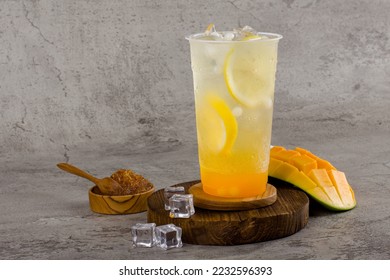 Boba or tapioca pearls is taiwan bubble milk tea in plastic cup with mango lemon flavor on texture  background, summers refreshment. - Powered by Shutterstock