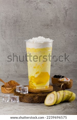 Boba or tapioca pearls is taiwan bubble milk tea in plastic cup with Banana flavor on texture  background, summers refreshment.