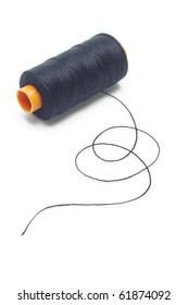 Bobbin Of Black Cotton Thread On White Background