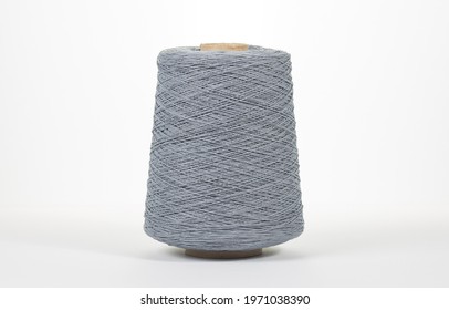 Bobbin of yarn on a white background. Side view. Textile spool on an isolated white background. Close-up. - Powered by Shutterstock