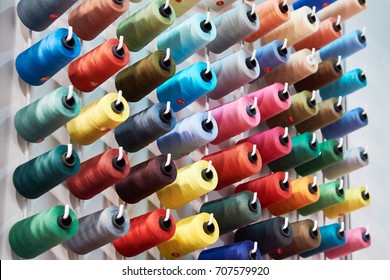Bobbins with colored thread for industrial textile machines
