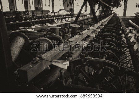 Bobbins and machines at an abandoned silk mill.