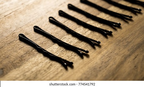 Bobby pins isolated on wood texture