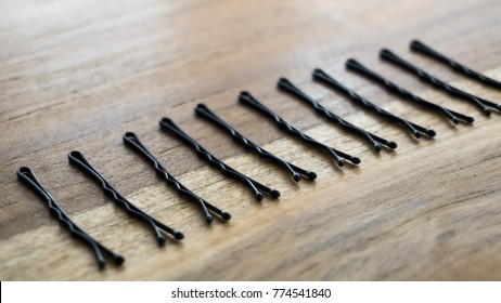 Bobby pins isolated on wooden background