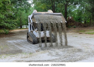 Bobcat Tractor Moving And Unloading Gravel On Old Road Reconstruction Site