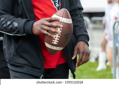 Boca Raton, Florida/USA - December 21, 2019: Florida Atlantic Owls Vs SMU Mustangs. Cheribundi Boca Raton Bowl 2019. Afro-American Man Holding Football Ball In A Hand