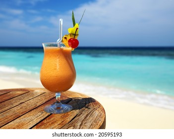 Bocal of fruity cocktail on a beach table - Powered by Shutterstock