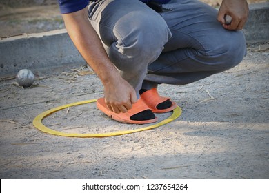 Bocce Ball In The Hands Of Men. A Man Playing Petanque.