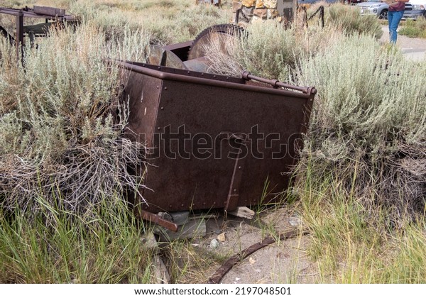 Bodie\
Ghost Town, California, August 10, 2022: The famous Bodie Ghost\
Town Looking at a Mining Car Rusting in the\
Desert