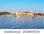 The Bodrum Castle of St. Peter and marina with boats in Bodrum city. Bodrum is a city in Mugla Province, Turkey.