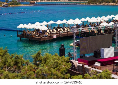 Bodrum, Mugla/Turkey - 07.30.2016: People Relaxing On The Terrace On The Beach Of Aegean Sea. Territory Of Rixos Premium Bodrum Hotel, Mugla, Turkey. Summer Vacation In Luxury Turkish Hotel.