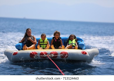 Bodrum - Turkey - August 25, 2017 : Happy Family Having Fun By Doing Watersports In Bodrum -Turkey