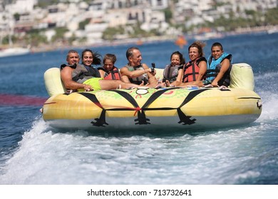 Bodrum - Turkey - August 25, 2017 : Happy Family Having Fun By Doing Watersports In Bodrum -Turkey