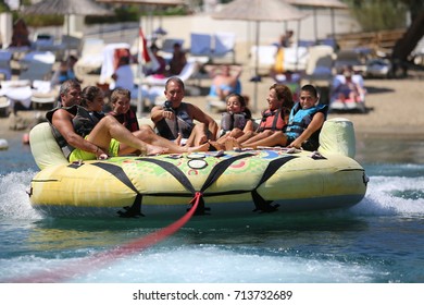 Bodrum - Turkey - August 25, 2017 : Happy Family Having Fun By Doing Watersports In Bodrum -Turkey