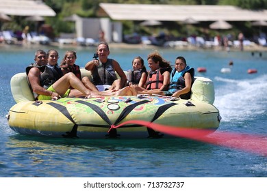 Bodrum - Turkey - August 25, 2017 : Happy Family Having Fun By Doing Watersports In Bodrum -Turkey